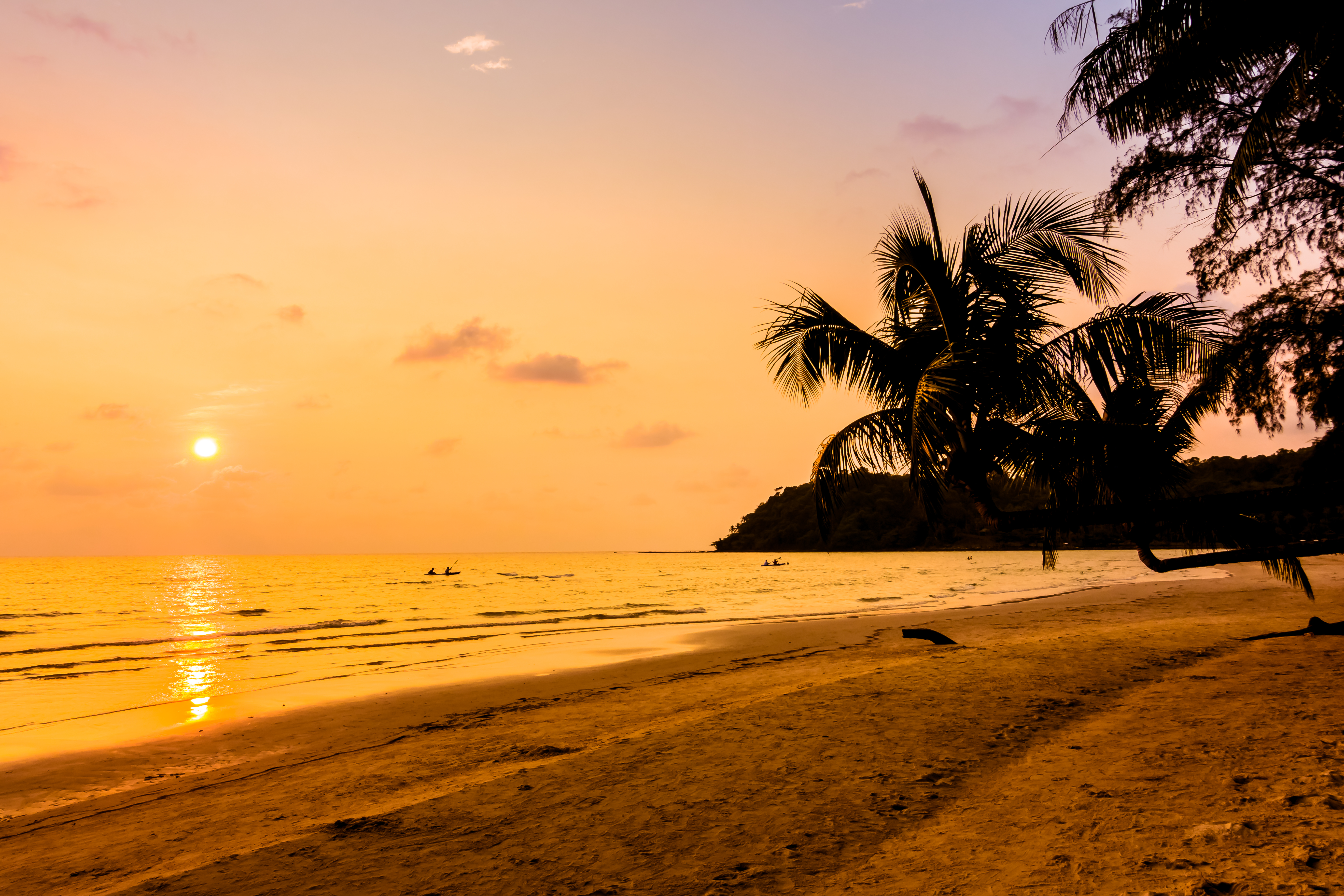 A beautiful beach in Goa at sunset with yoga practitioners